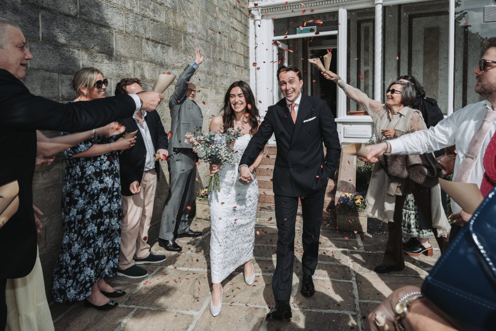 Groom and g roomsm en portrait outside Harrogate Register Office