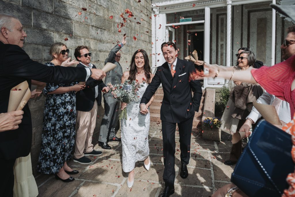 Joyful wedding group photo shot at Bilton House garden entrance